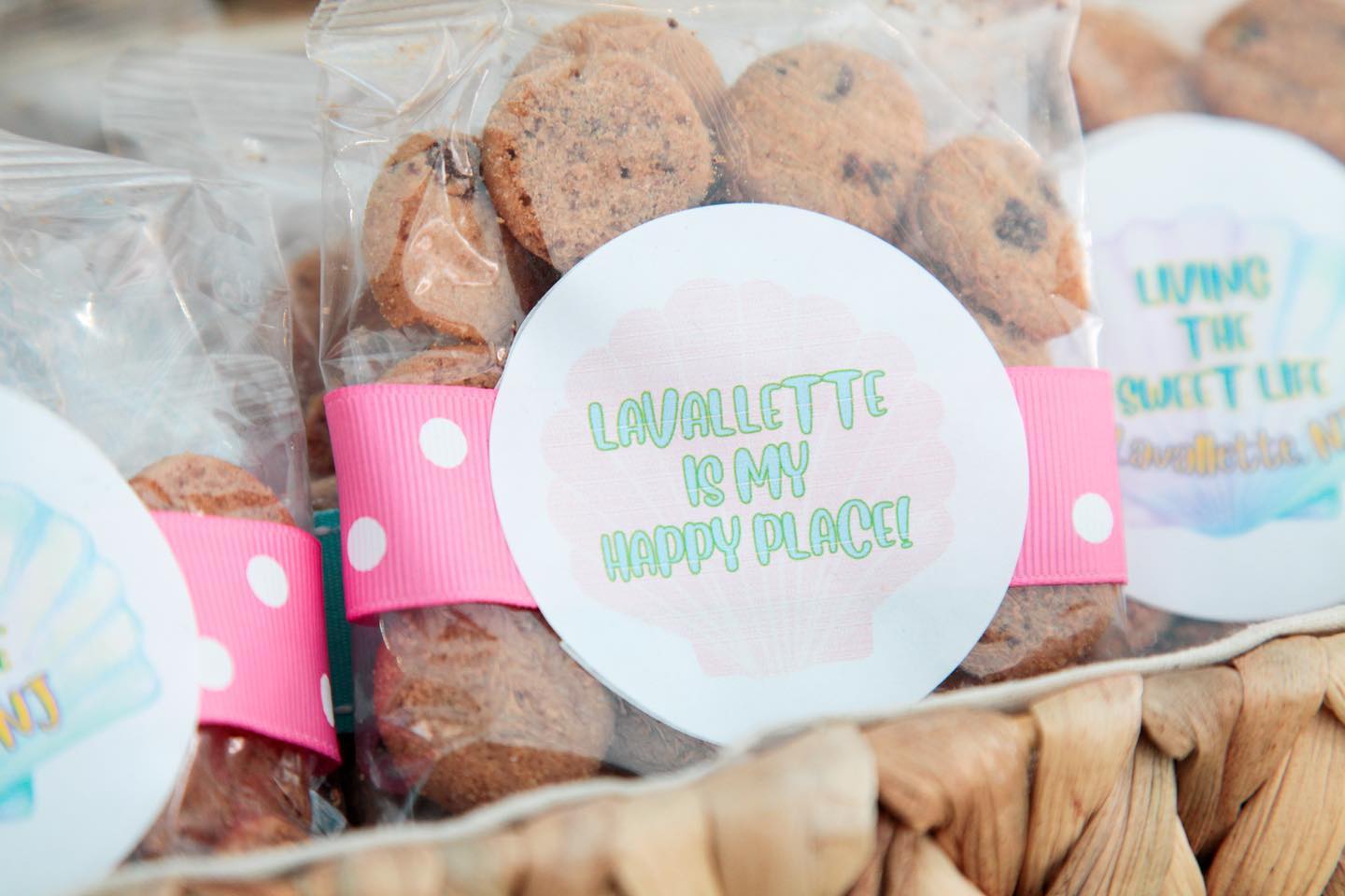 A bag of cookies with a pink ribbon around it.