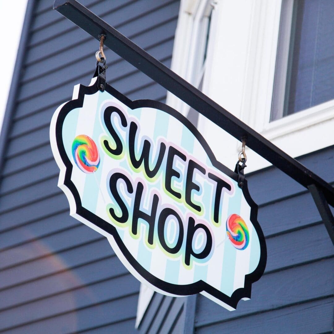 A sign that says " sweet shop ".