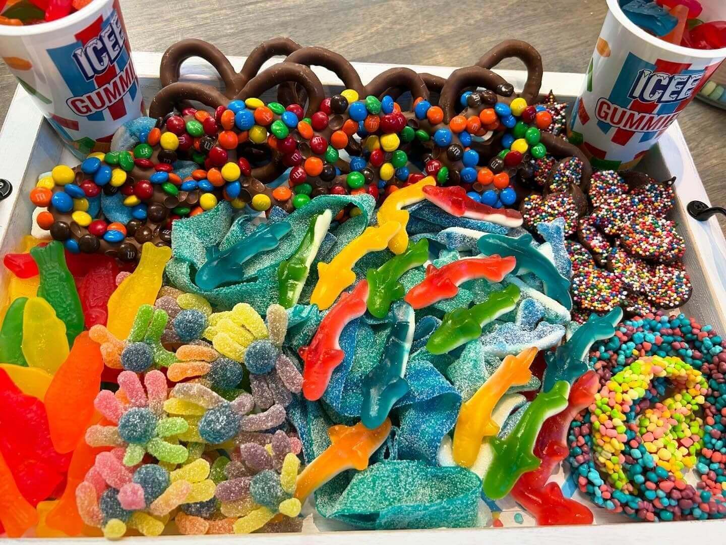 A tray of candy is shown with pretzels and other treats.