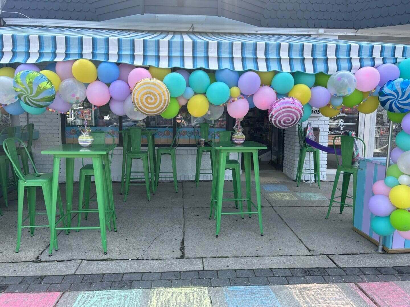 A bunch of balloons are hanging from the roof