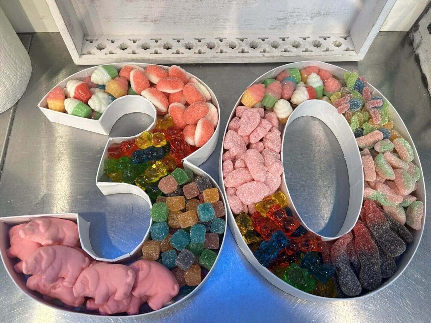 A large number of different colored candies in the shape of 3 0.