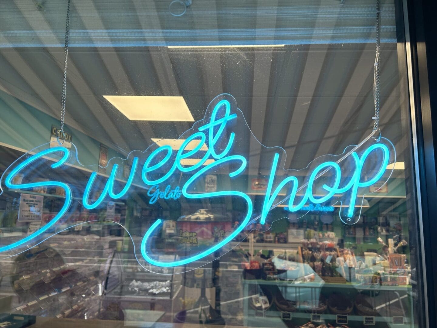 A neon sign in the window of a store.