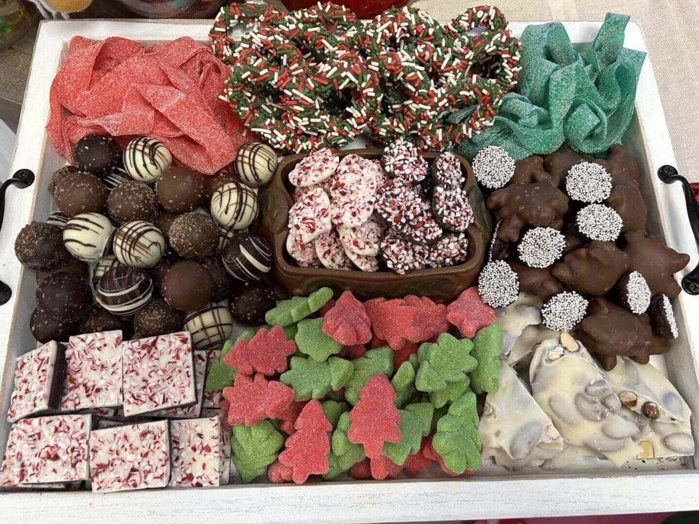 A tray of assorted christmas cookies and chocolates.