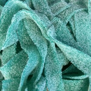 Close-up of teal-colored sour candy strips covered in sugar.
