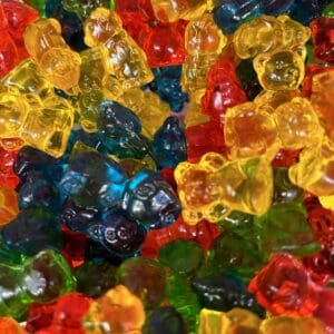 Colorful gummy bears piled together in a close-up shot.