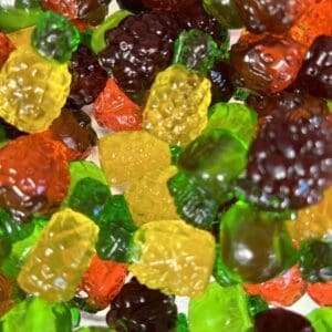 Colorful gummy bears and berry-shaped candies mixed together.