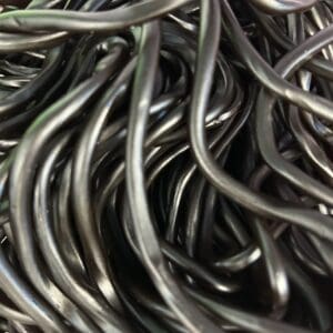 Close-up of tangled metallic wires with a shiny, reflective surface.