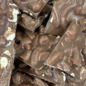 Close-up of chocolate bark with nuts and crispy pieces.