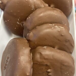 Close-up of chocolate-covered cookies arranged in a row.