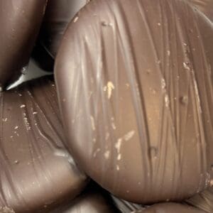 Close-up of textured chocolate with small bits embedded.