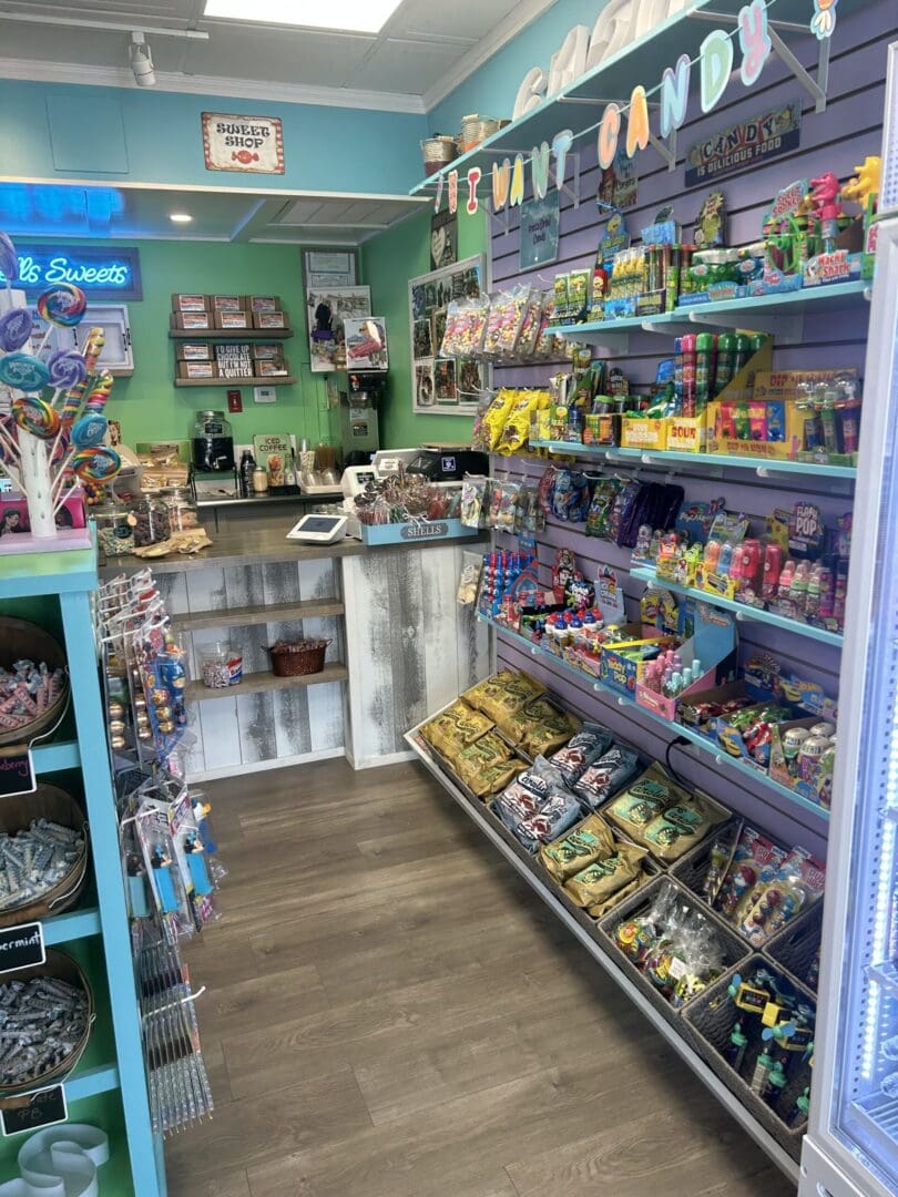 A colorful candy store filled with various sweets and snacks on shelves.