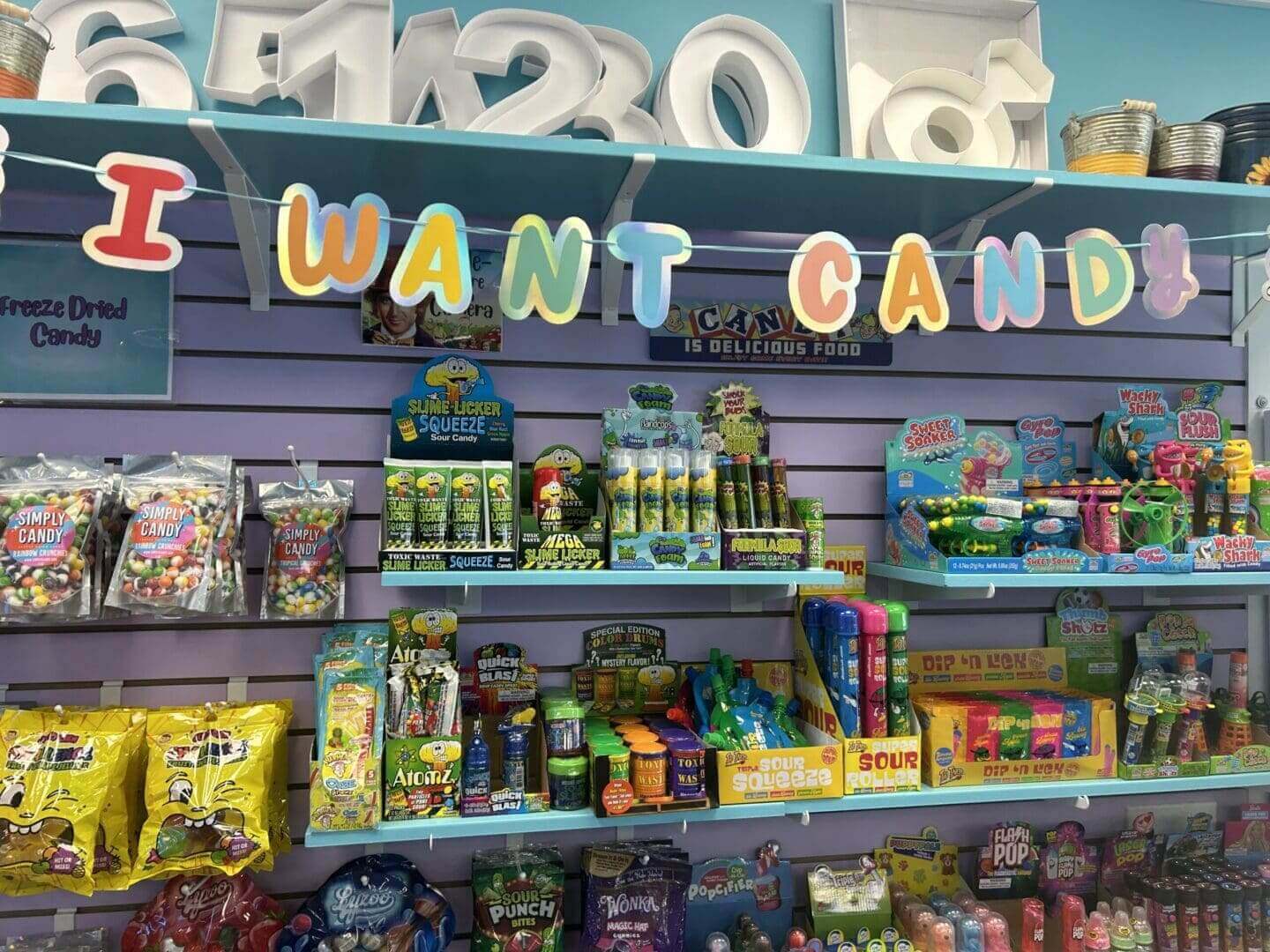 Colorful candy store display with various sweets and toys.