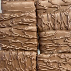 Close-up of chocolate-covered bars with drizzled chocolate on top.