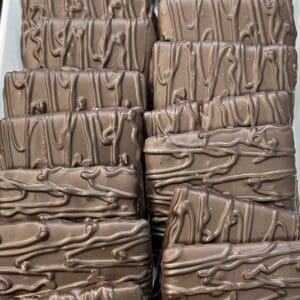 Stacks of chocolate bars with decorative drizzle.