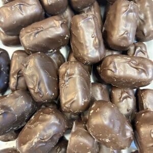 Close-up of chocolate-covered candies piled together.
