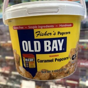 A container of Fisher's Popcorn coated with Old Bay seasoning and caramel.