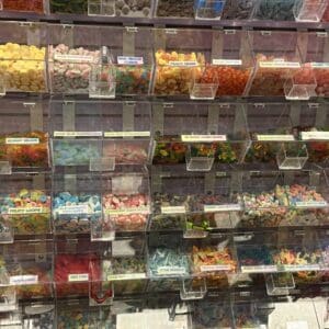 A wall of colorful bulk candy bins in a store.