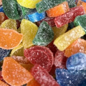 Colorful sugar-coated gummy candies piled together.
