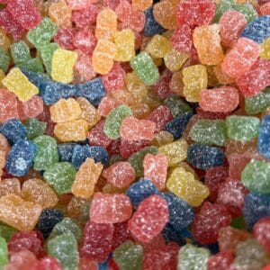 Colorful gummy bears piled together in various bright colors.