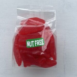 Clear bag of red gummy candies labeled nut free.