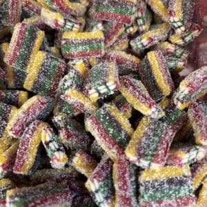 Colorful sour rainbow gummy candies coated with sugar.