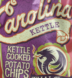 Close-up of Carolina Kettle Cooked Potato Chips bag with dragon logo.