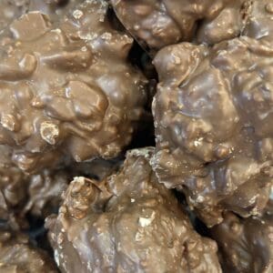 Close-up of chocolate-covered nut clusters.