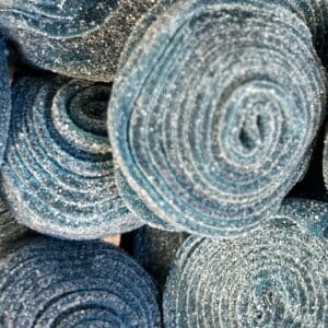 Rolled-up coir mats stacked together.