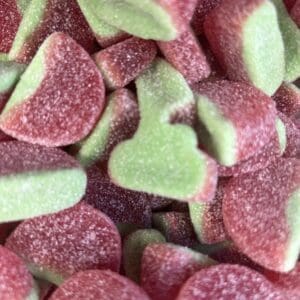 Close-up of red and green gummy candies coated in sugar.
