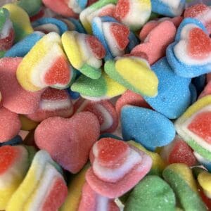 Colorful heart-shaped gummy candies in various pastel shades.