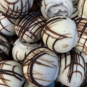 White chocolate truffles drizzled with dark chocolate.