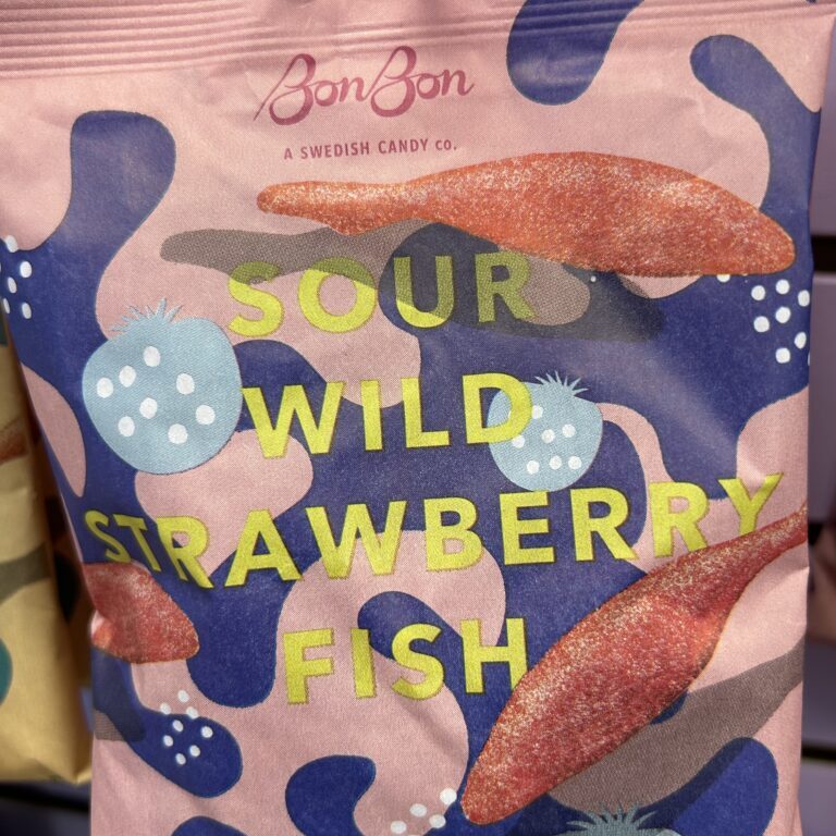 Colorful packaging with "Sour Wild Strawberry Fish" text and playful shapes.