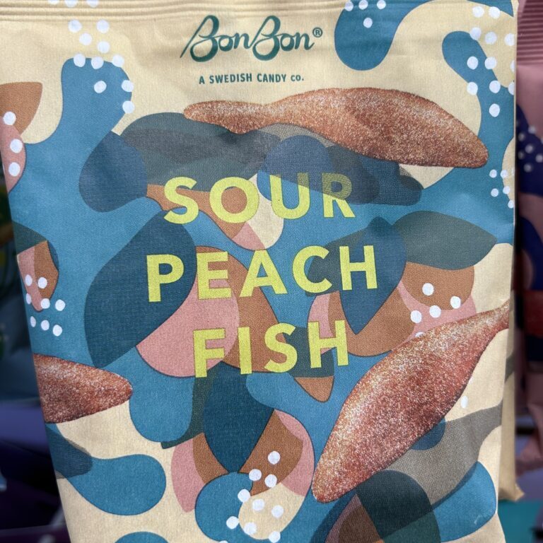 Colorful packaging of sour peach fish candy with fish illustrations.