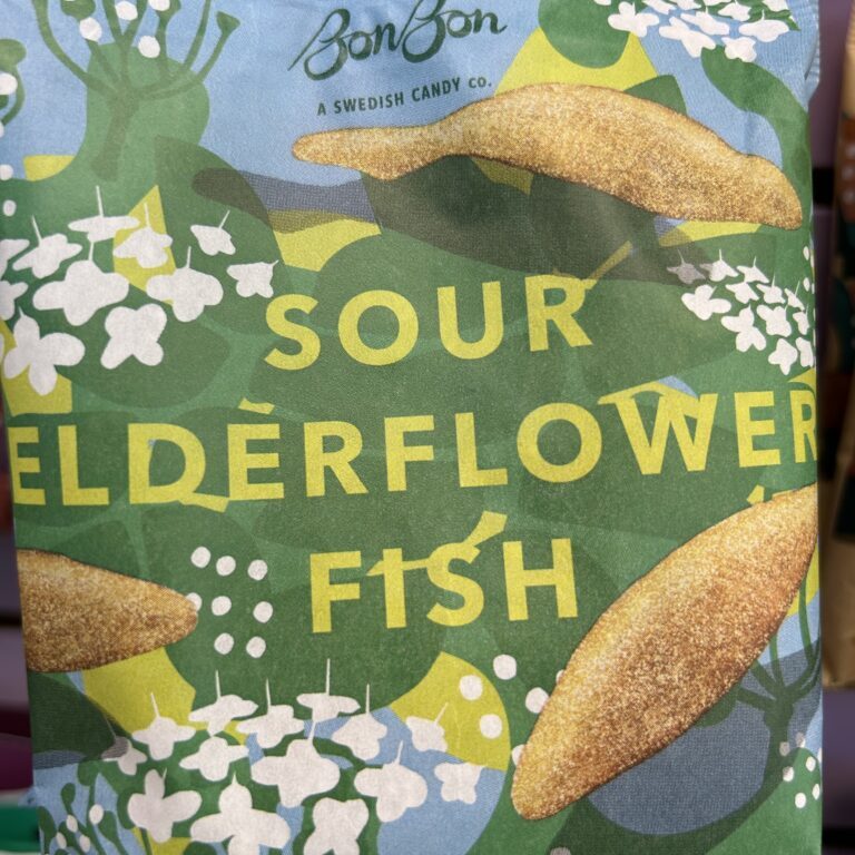 A colorful package of Sour Elderflower Fish candy with floral designs.